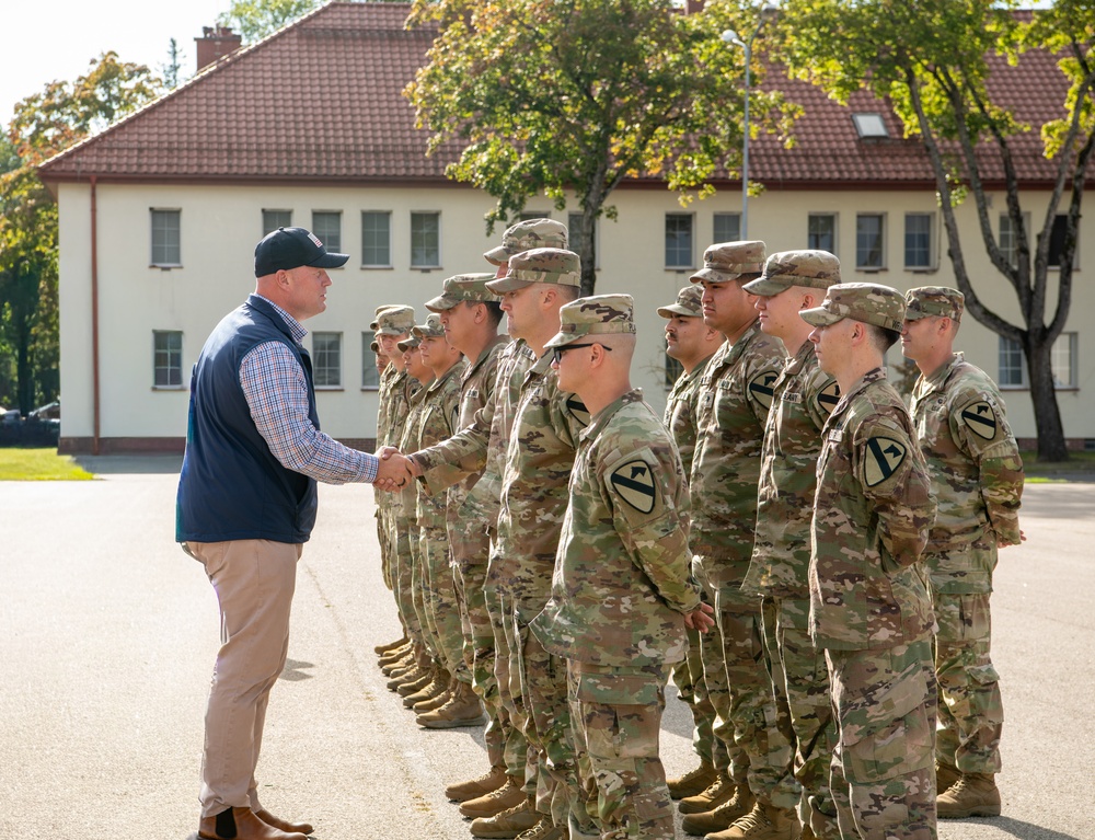 U.S. Ambassador to NATO Whitaker shakes hands with Task Force Iron Soldiers in Poland