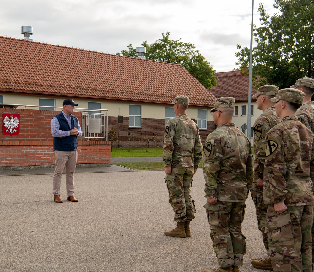 U.S. Soldiers stand in formation as U.S. Ambassador to NATO delivers remarks
