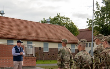 U.S. Soldiers stand in formation as U.S. Ambassador to NATO delivers remarks