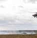 U.S. Apache flies over Abrams tanks during Iron Defender-25