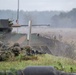 Polish Land Forces soldiers take defensive positions with a Polish Abrams tank