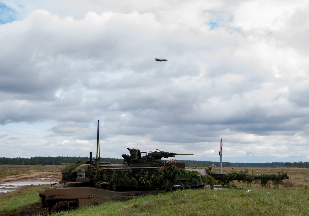Polish Abrams tank holds position as Dutch F-35 provides air support at Iron Defender 25