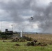 Polish soldiers take defensive positions with Hind helicopters overhead