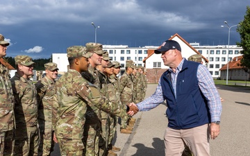 U.S. Ambassador to NATO shakes hands with U.S. Army Soldiers after Iron Defender-25