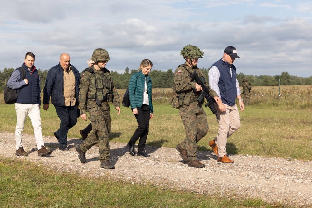 U.S. Ambassador to NATO walks alongside Polish Land Forces officers at Iron Defender-25