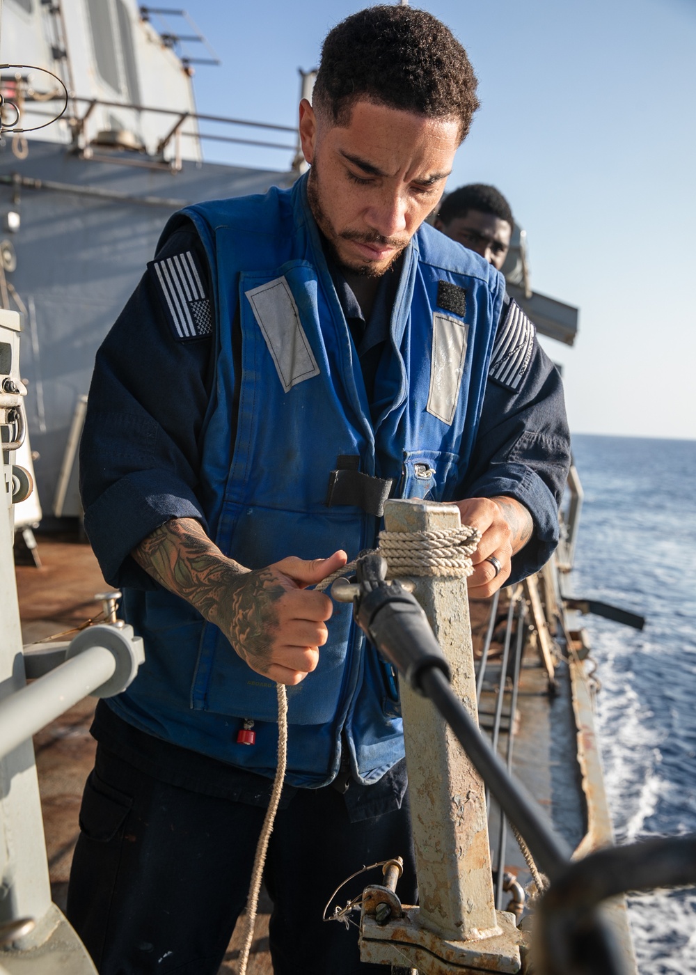 USS Mitscher (DDG 57) Sailor secures line during Sea-and-Anchor