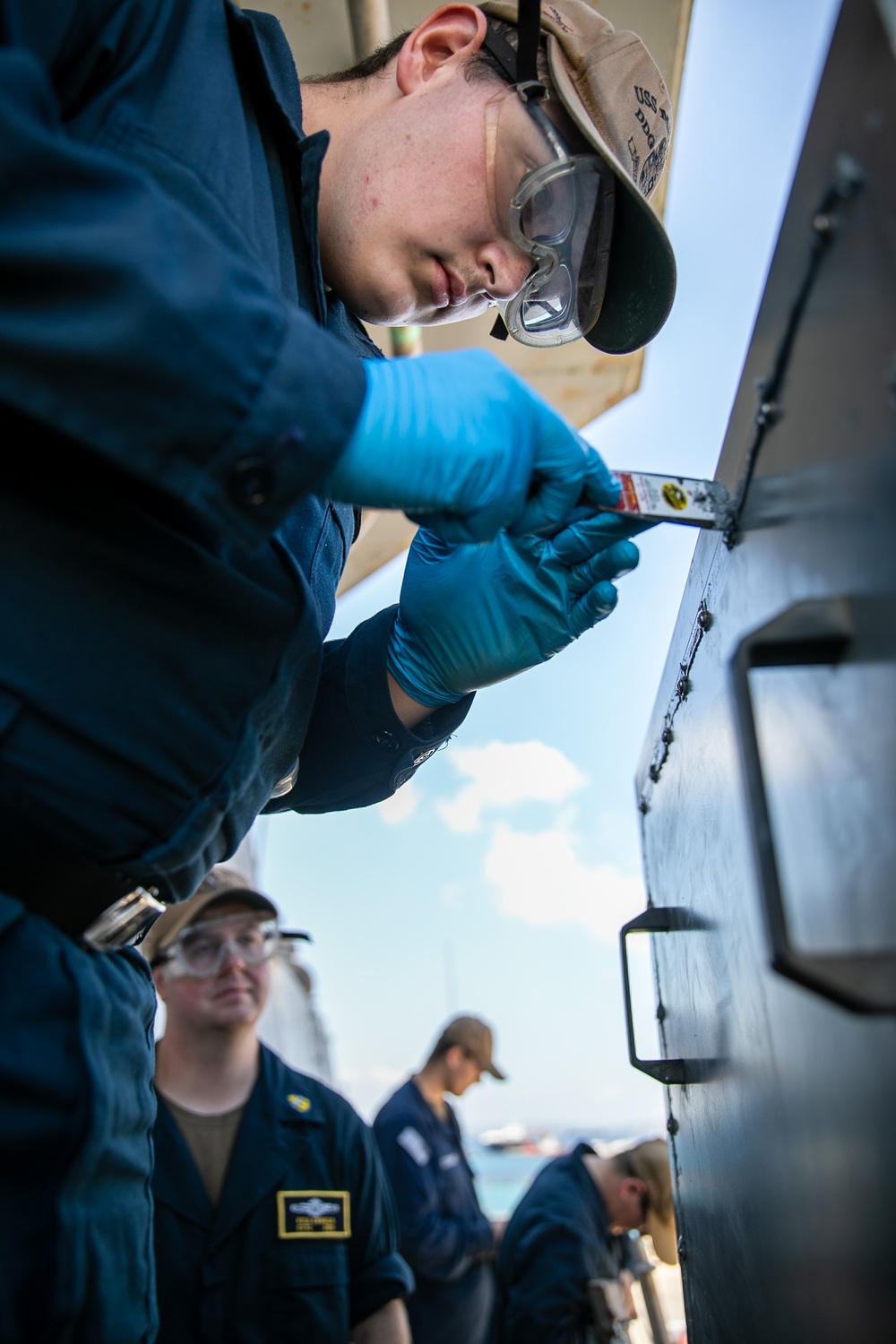 USS Mitscher (DDG 57) Sailor conducts maintenance