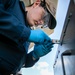 USS Mitscher (DDG 57) Sailor conducts maintenance