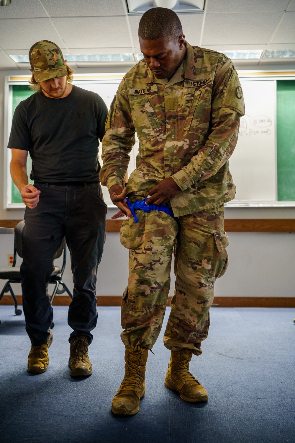 U.S. Marshal Instructs Guardsman on Tourniquet Application Techniques