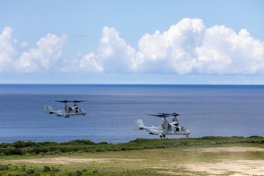U.S. Marines, Sailors, Japan Ground Self-Defense Force members refuel AH-64 Apaches with MV-22B Ospreys