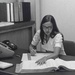 Auditor reviewing a contractor's general ledger. A Frieden calculator is on the desk.