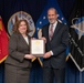 Ms. Anita Bales and the Honorable McCord pose with Ms. Bales Certificate of Retirement