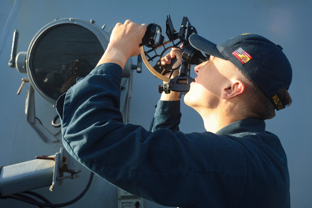QMSA Jace Orourke takes a solar azimuth reading from the USS Bulkeley (DDG 84)
