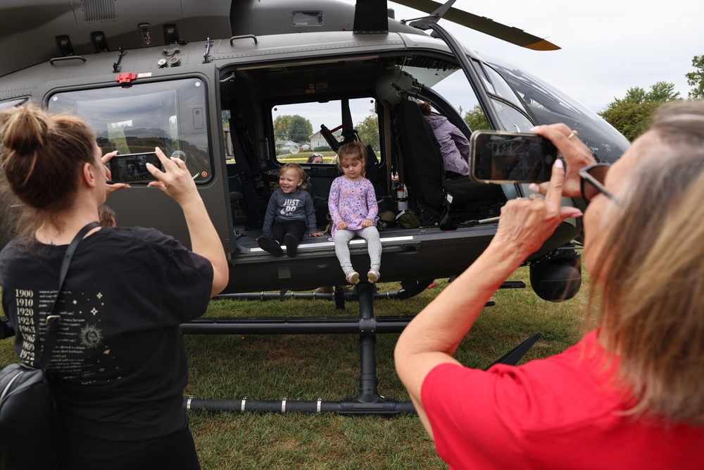 Children pose in an Iowa National Guard UH-72 Lakota at Wall of Remembrance Ceremony