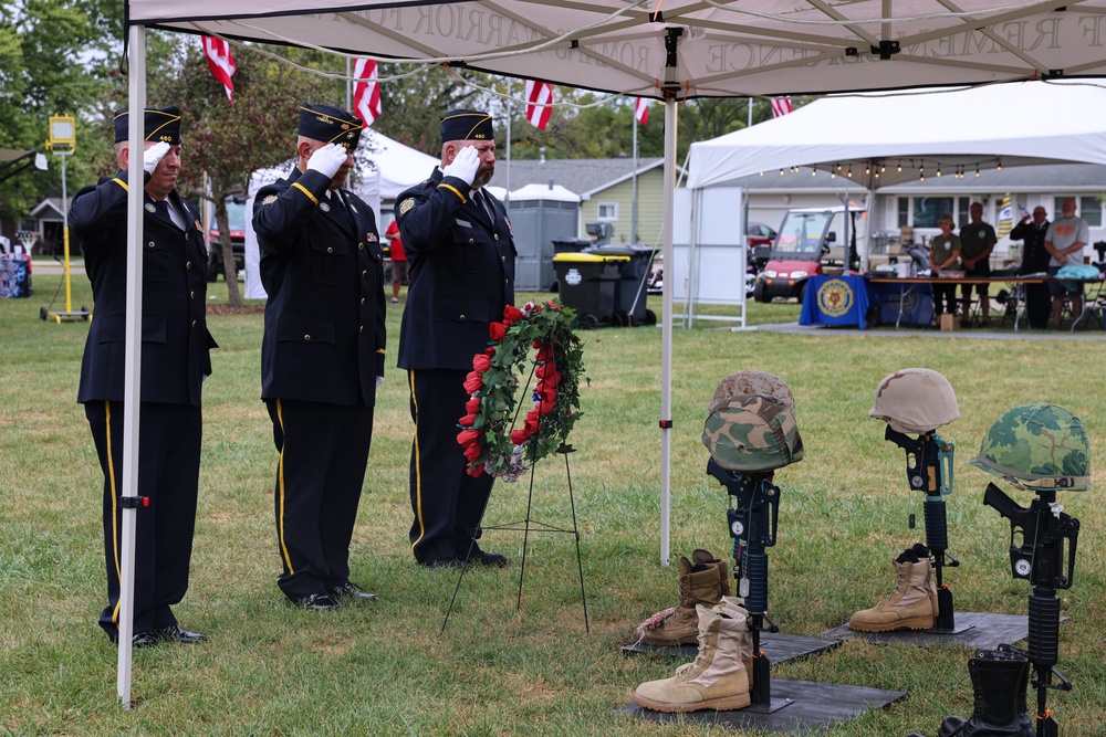 American Legion members place wreath and salute at Wall of Remembrance ceremony in Solon, Iowa