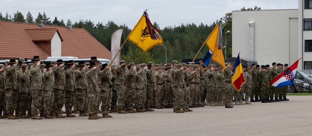 U.S. and NATO Forces salute during the transfer of authority ceremony in Poland