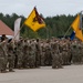 U.S. and NATO Forces salute during the transfer of authority ceremony in Poland
