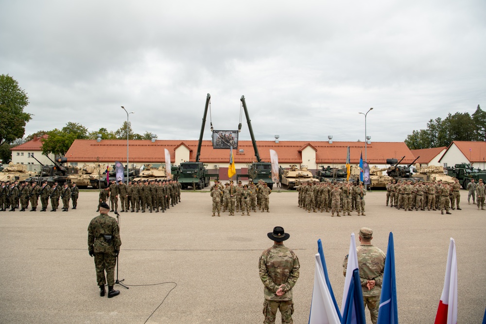 U.S. and Allied soldiers stand in formation during the Battlegroup transfer of authority