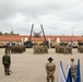 U.S. and Allied soldiers stand in formation during the Battlegroup transfer of authority