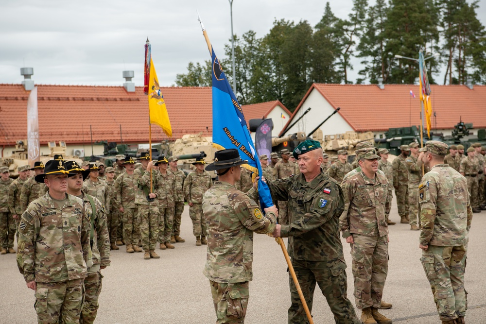 U.S. and Polish leaders conduct change of colors during NATO transfer of authority