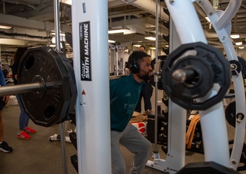 Sailors participate in Morale, Welfare and Recreation weight lifting competition.