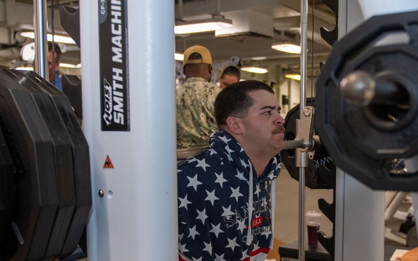 Sailors participate in Morale, Welfare and Recreation weight lifting competition.