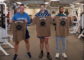Sailors participate in Morale, Welfare and Recreation weight lifting competition.