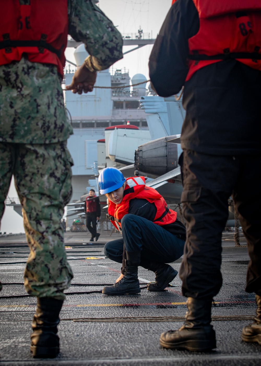 USS Gerald R. Ford (CVN 78) Sailor Adjusts Line During Replenishment-at-Sea
