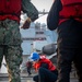 USS Gerald R. Ford (CVN 78) Sailor Adjusts Line During Replenishment-at-Sea