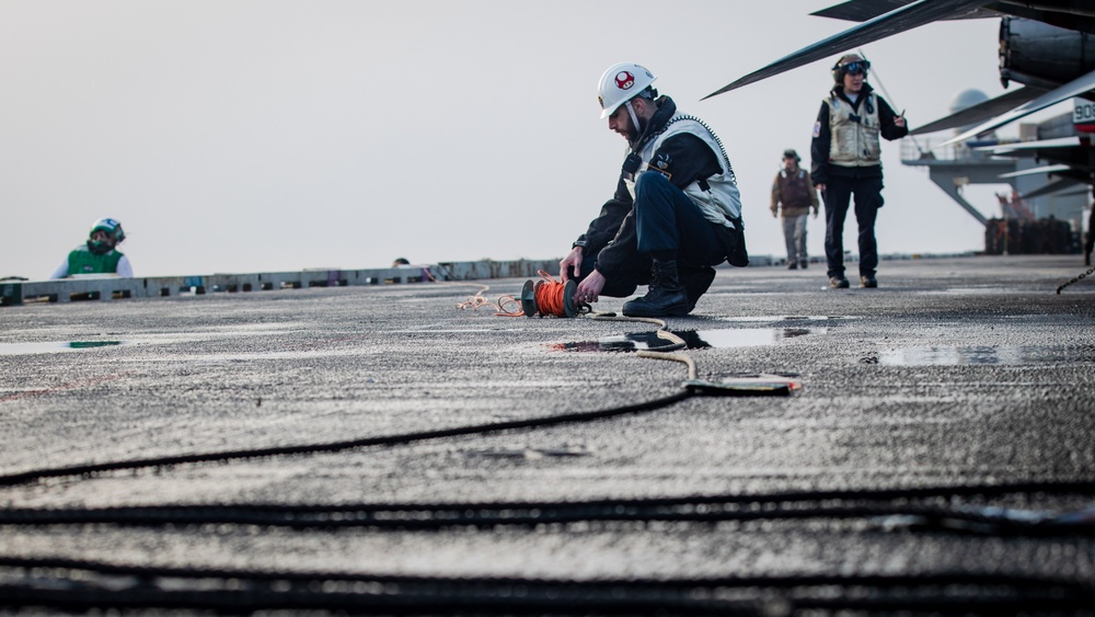 USS Gerald R. Ford (CVN 78) Sailor Adjusts Sound-Powered Telephone Line