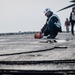 USS Gerald R. Ford (CVN 78) Sailor Adjusts Sound-Powered Telephone Line