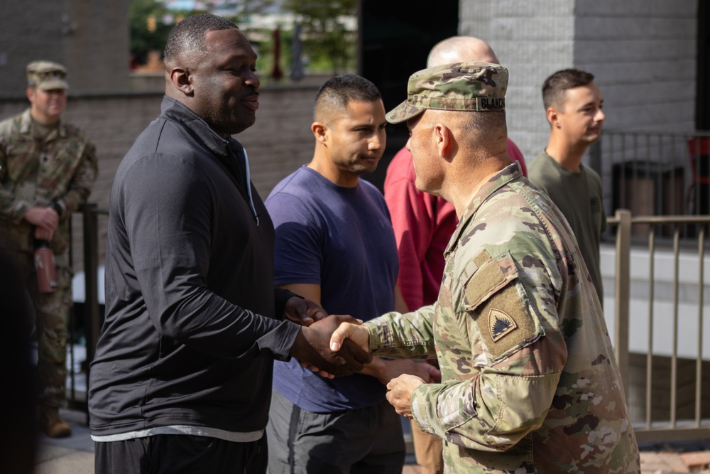 U.S. Army Brig. Gen. Leland D. Blanchard presents a coin to a U.S. Soldier