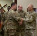 U.S. Army Brig. Gen. Leland D. Blanchard presents a coin to a U.S. Soldier