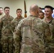 U.S. Army Brig. Gen. Leland D. Blanchard presents a coin to a U.S. Soldier