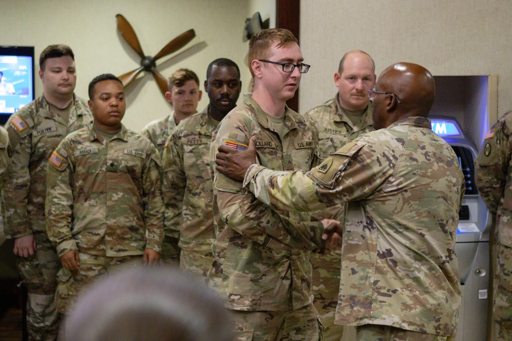 U.S. Army Command Sgt. Maj. Ronald L. Smith Jr. presents a coin to a U.S. Soldier