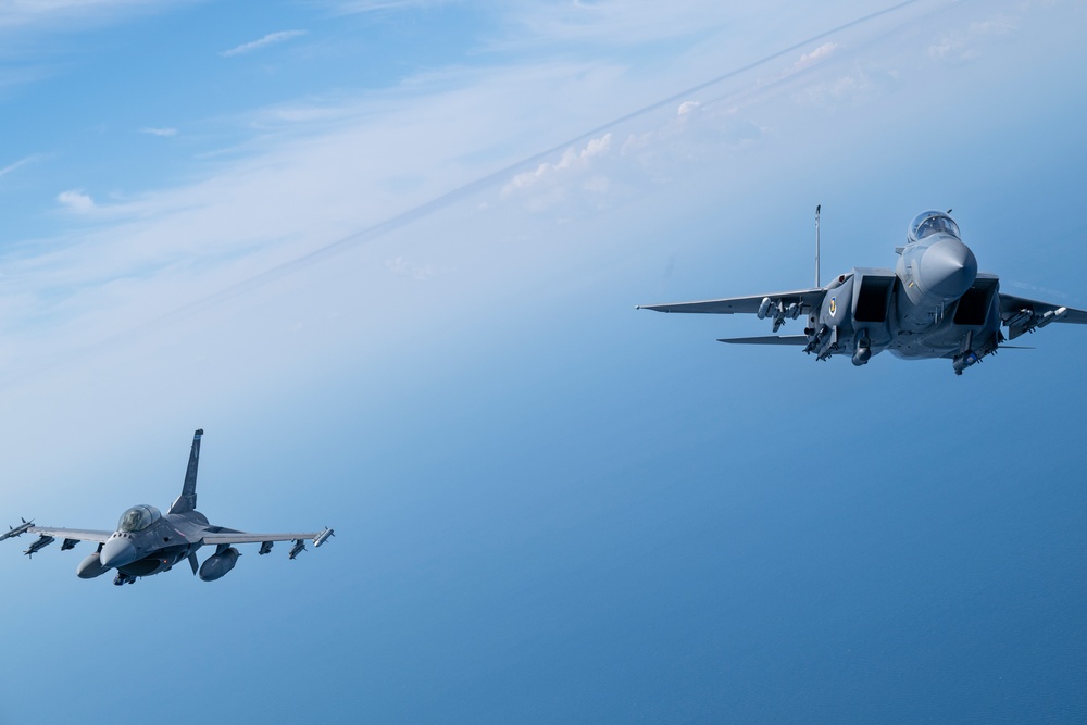 F-15EX Eagle II and F-16D Fighting Falcon fly over the Gulf of America