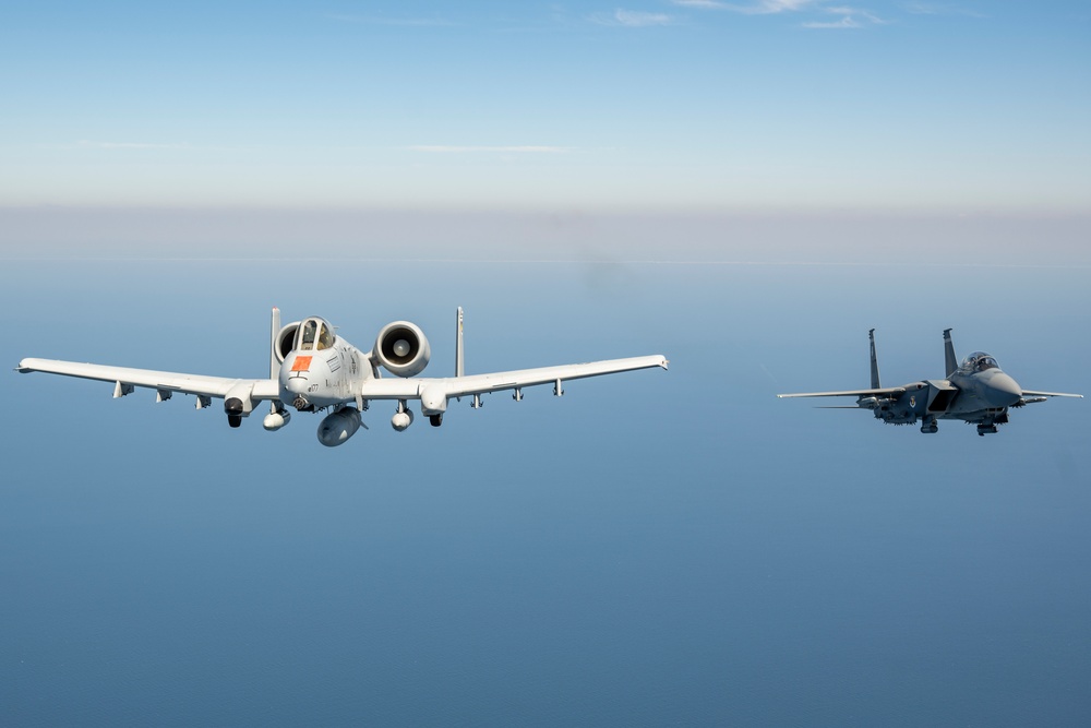 F-15EX Eagle II and A-10C Thunderbolt II fly over the Gulf of America