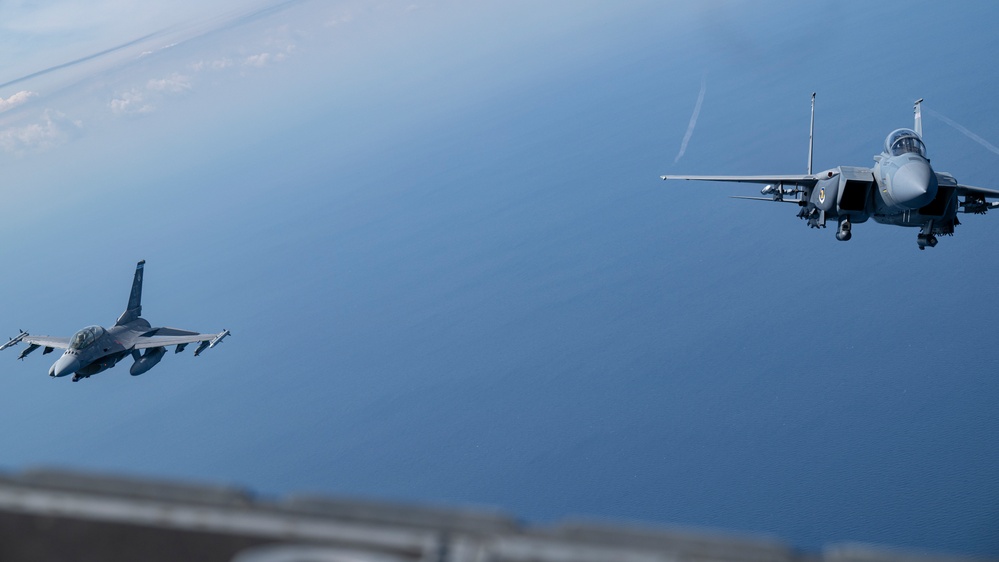F-15EX Eagle II and F-16D Fighting Falcon fly over the Gulf of America
