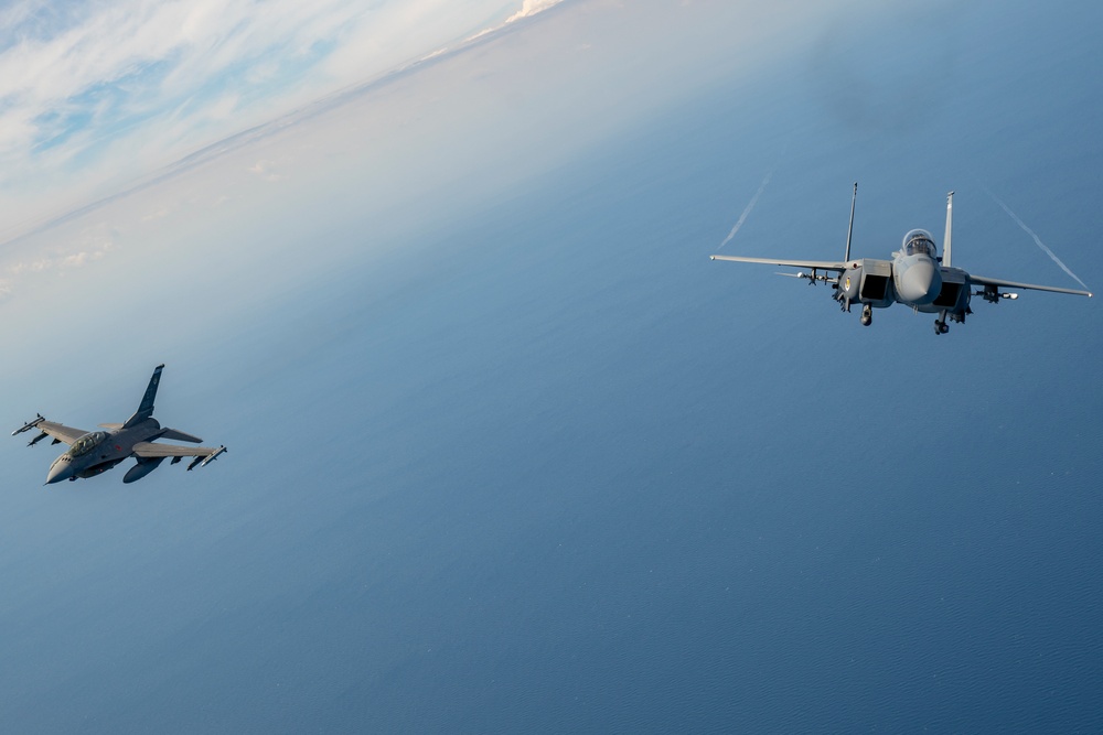 F-15EX Eagle II and F-16D Fighting Falcon fly over the Gulf of America