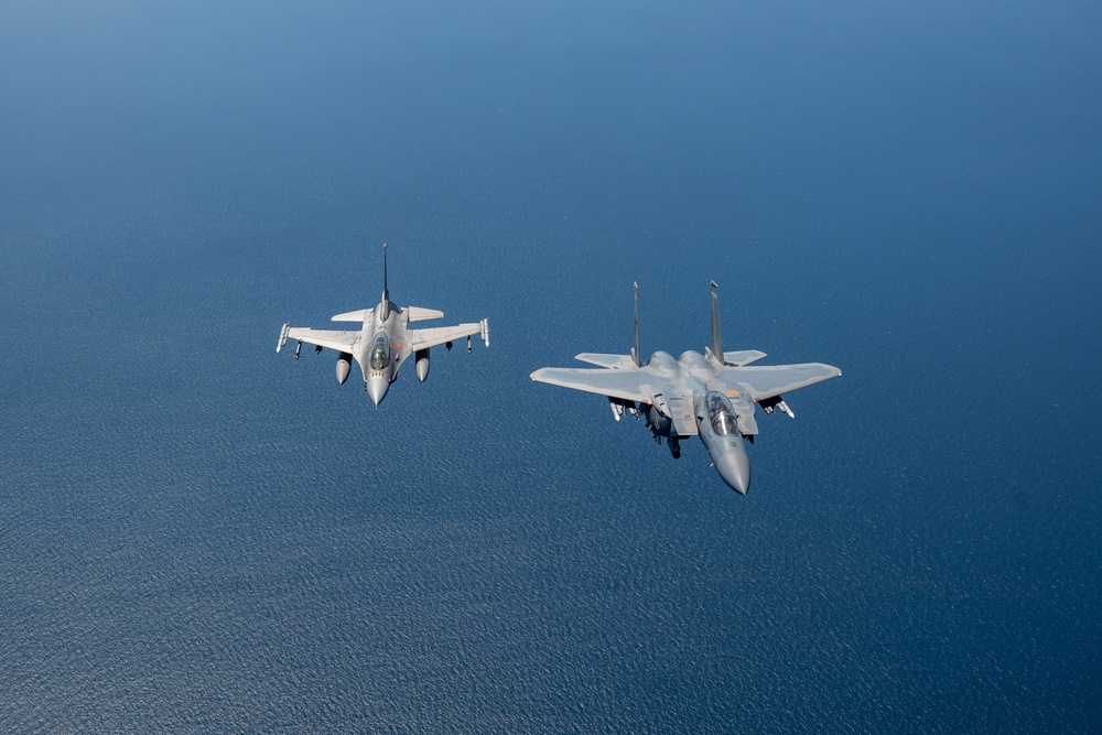 F-15EX Eagle II and F-16D Fighting Falcon fly over the Gulf of America