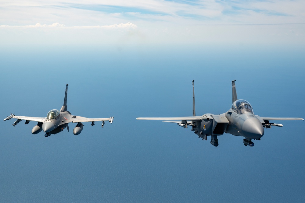 F-15EX Eagle II and F-16D Fighting Falcon fly over the Gulf of America
