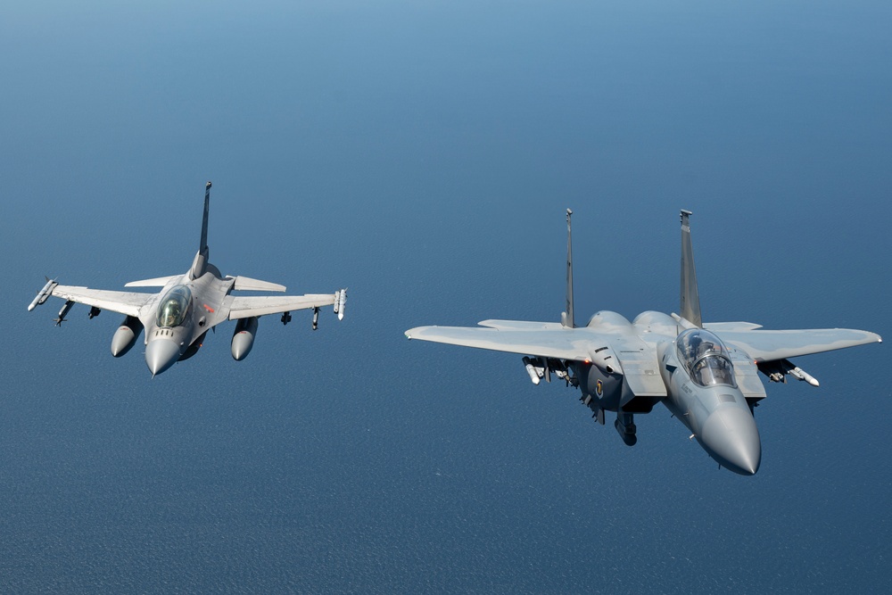F-15EX Eagle II and F-16D Fighting Falcon fly over the Gulf of America