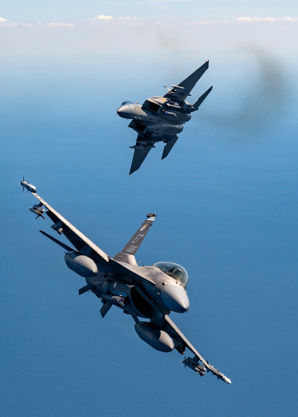 F-15EX Eagle II and F-16D Fighting Falcon fly over the Gulf of America
