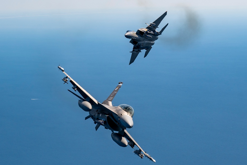 F-15EX Eagle II and F-16D Fighting Falcon fly over the Gulf of America