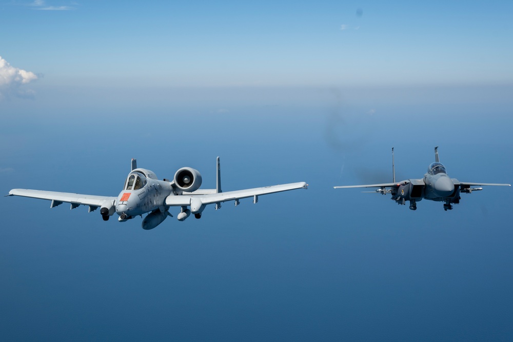 F-15EX Eagle II and A-10C Thunderbolt II fly over the Gulf of America