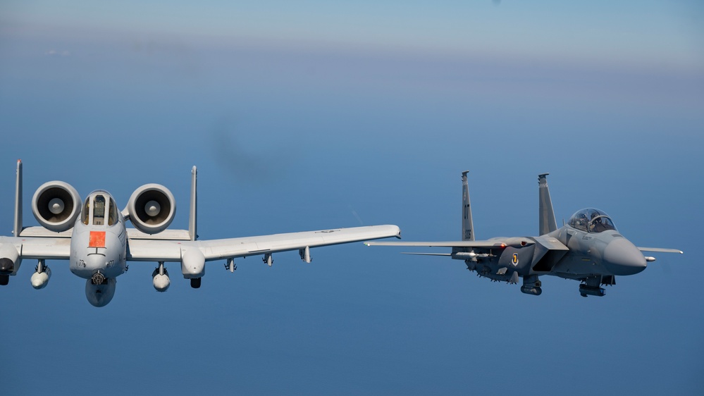F-15EX Eagle II and A-10C Thunderbolt II fly over the Gulf of America