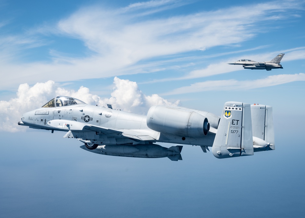 An F-16D and A-10C fly over the Gulf of America