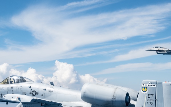 An F-16D and A-10C fly over the Gulf of America