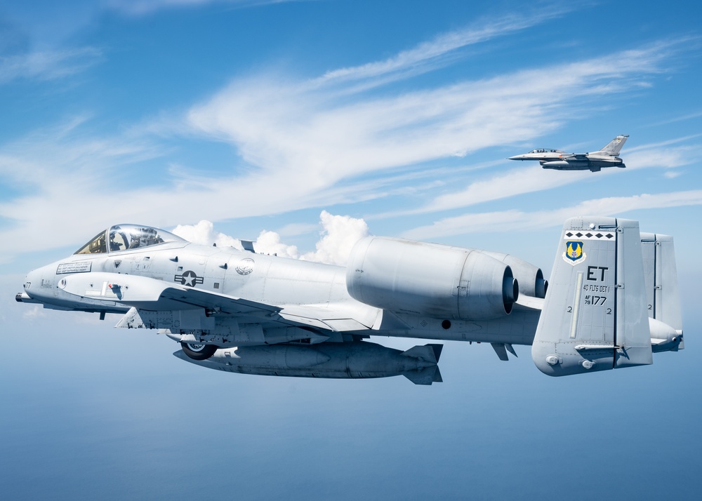 An F-16D and A-10C fly over the Gulf of America