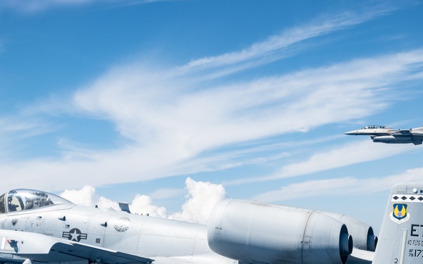 An F-16D and A-10C fly over the Gulf of America